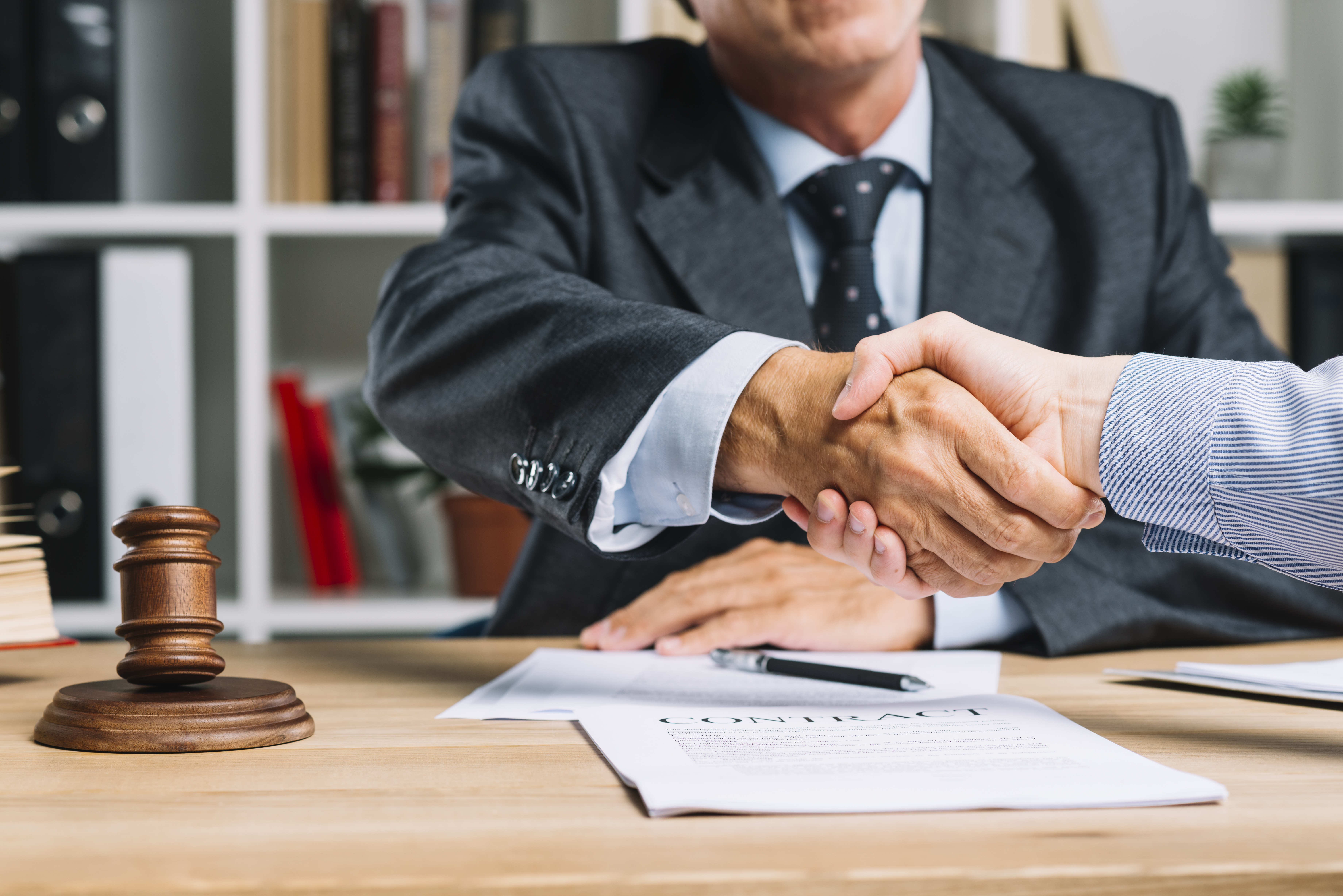 Lawyer shaking clients hand leading Social Security Disability Link